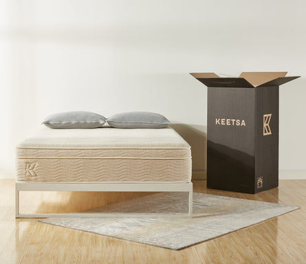 Keetsa best value bedding products with mattress and two pillows pictured next to packaging box