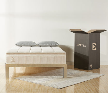 Keetsa best value bedding products with mattress and two pillows pictured next to packaging box