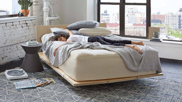Welcome to the comfort layers page. A woman is using a Keetsa luxury comfort layer on her mattress and deep sleeping on top of it in a very comfortable way.