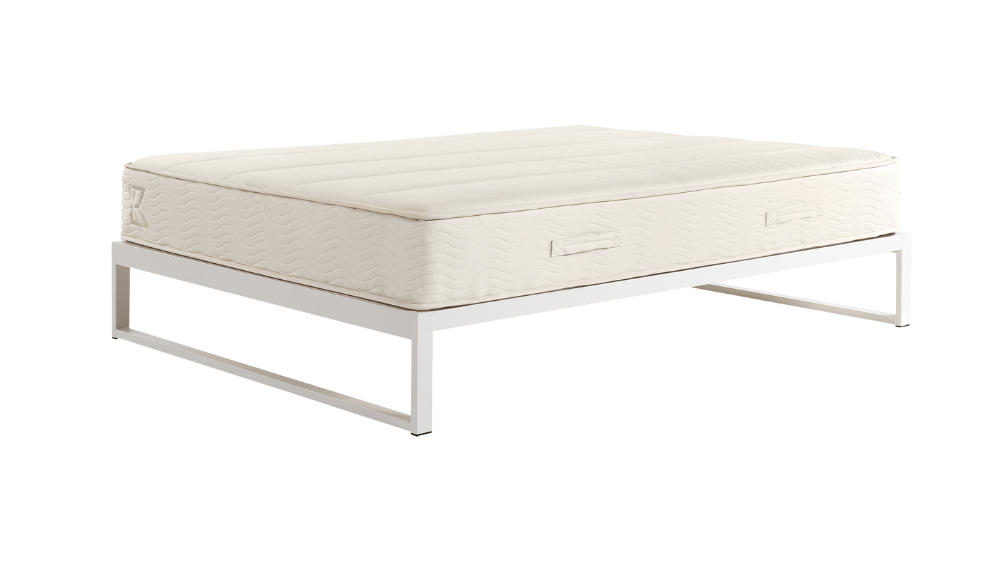 Keetsa Mínimo Industrial Snow White steel bed frame with Keetsa mattress, three-quarter angle showing white metal frame supporting cream wave-quilted mattress with branded handles.