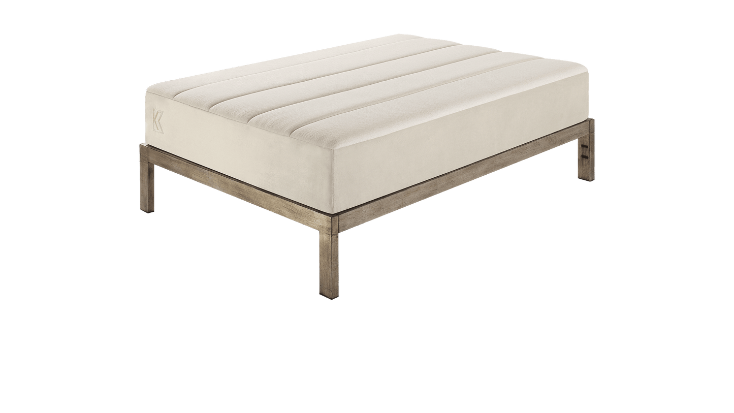 Keetsa Tea Leaf Supreme mattress shown on a wooden platform bed frame, illustrating its streamlined silhouette and compatibility with modern bed foundations.