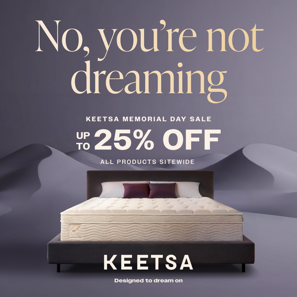 Keetsa Memorial Day Sale promotion offering up to 25% off all products sitewide, featuring a plush mattress on a modern platform bed against a dreamy purple landscape backdrop; text reads “No, you’re not dreaming” and “Designed to dream on” to emphasize comfort and savings.