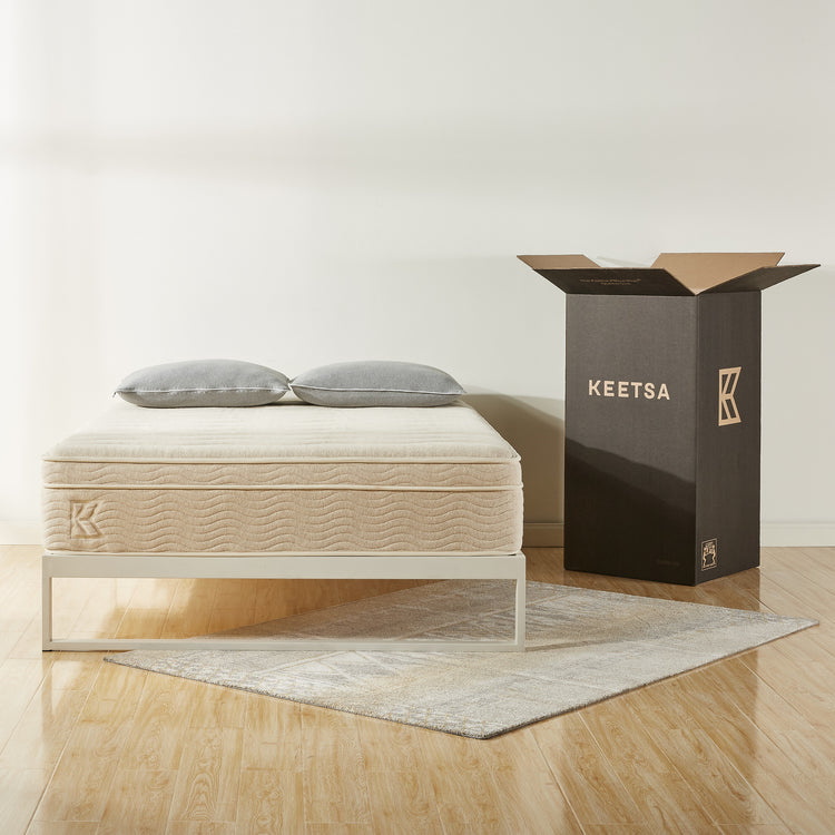 Keetsa best value bedding products with mattress and two pillows pictured next to packaging box