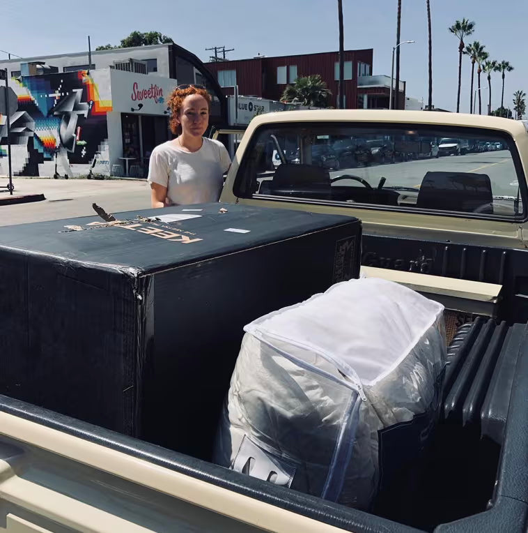 Customer with a Keetsa mattress box and wrapped mattress loaded in a vintage pickup truck