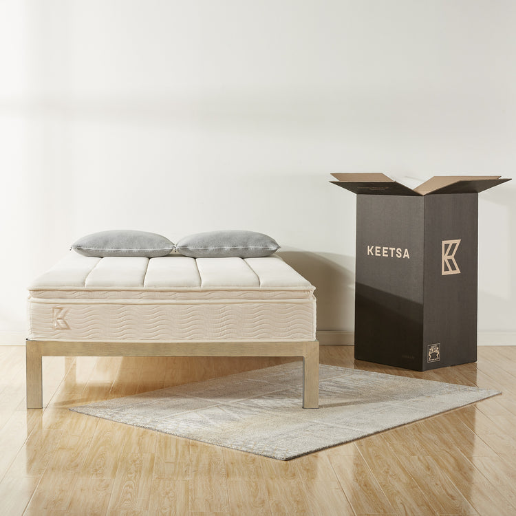 Keetsa best value bedding products with mattress and two pillows pictured next to packaging box