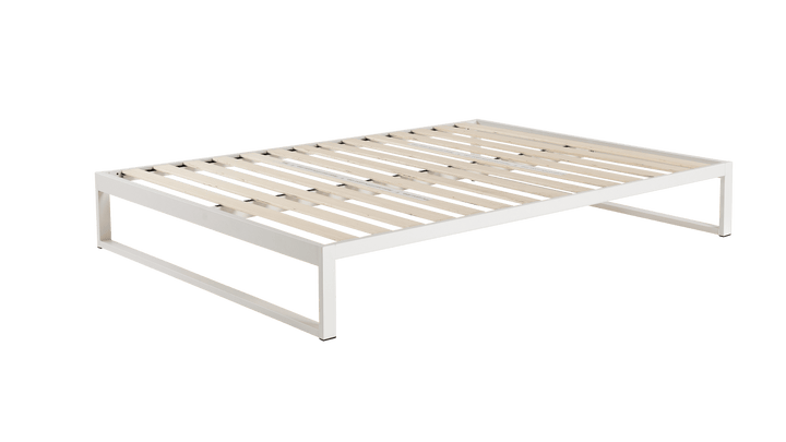Keetsa Mínimo Industrial Snow White steel bed frame, three-quarter overhead angle showing complete wooden slat platform with low-profile white metal frame and open rectangular legs.