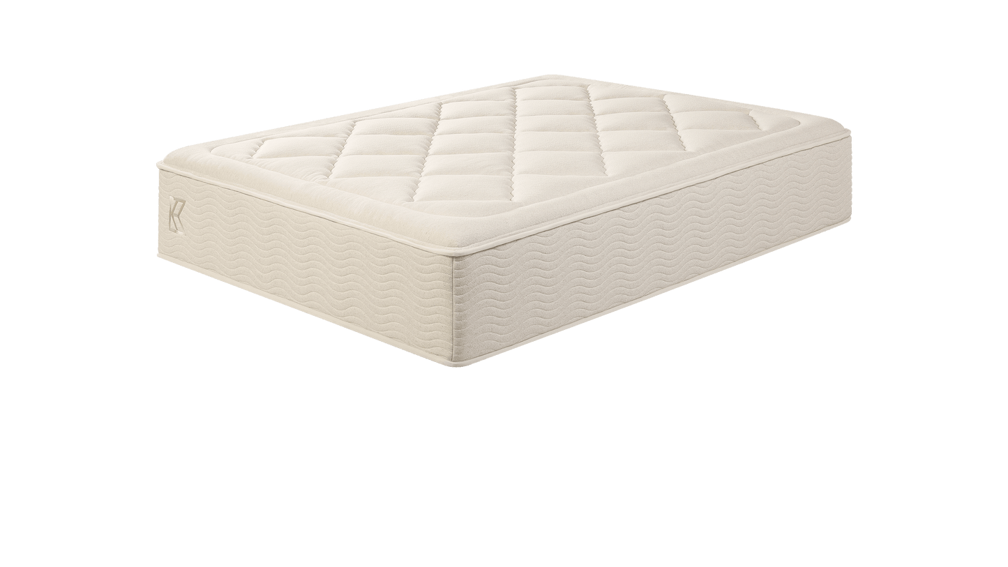 Tea Leaf Dream® mattress in beige with a quilted pillow-top and embroidered logo detail, designed to offer pressure-relieving comfort and reliable support for a restful night’s sleep.