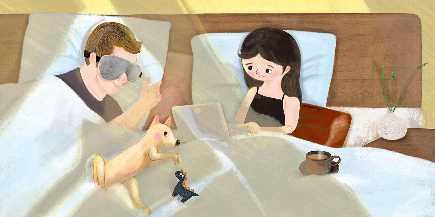 Keetsa eye mask lifestyle illustration of couple in bed with one person sleeping wearing the gray eye mask while partner works on laptop with dog and coffee nearby.