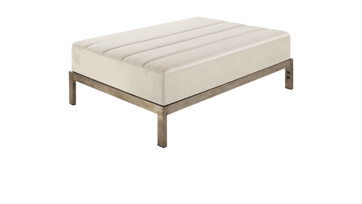 Keetsa Tea Leaf Supreme mattress shown on a wooden platform bed frame, illustrating its streamlined silhouette and compatibility with modern bed foundations.