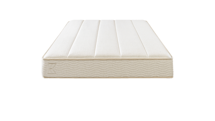 Keetsa Plus mattress in a nighttime bedroom setting as a man reaches to turn off a bedside lamp, emphasizing its supportive construction and inviting comfort for restful sleep.